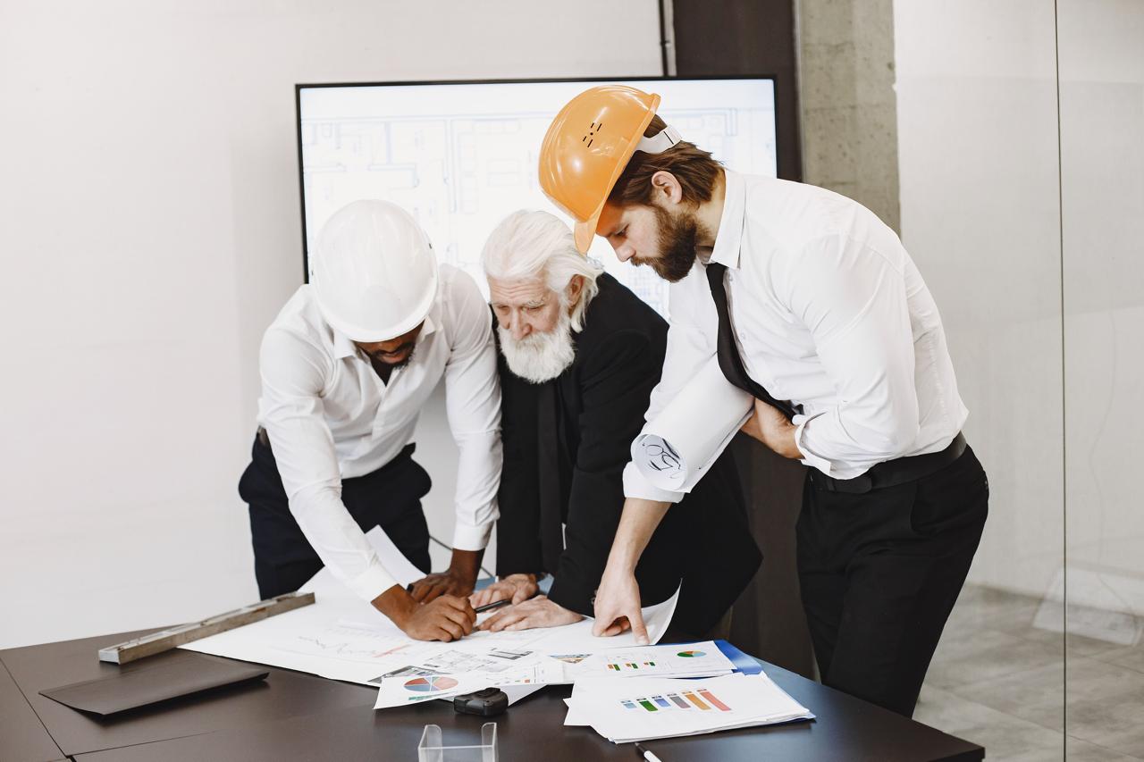 Engineering team reviewing project drawings